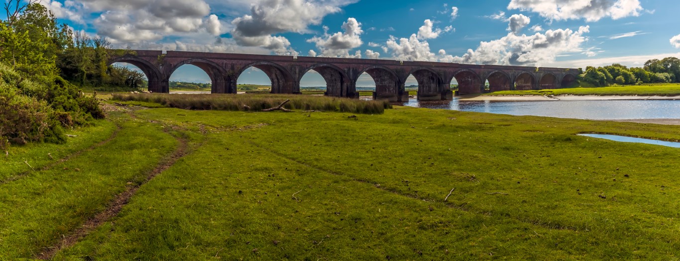 A view along the banks of the River Loughor at Pontarddulais towards the viaduct at Hendy, Wales in the summertime A bridge near LLanelli
