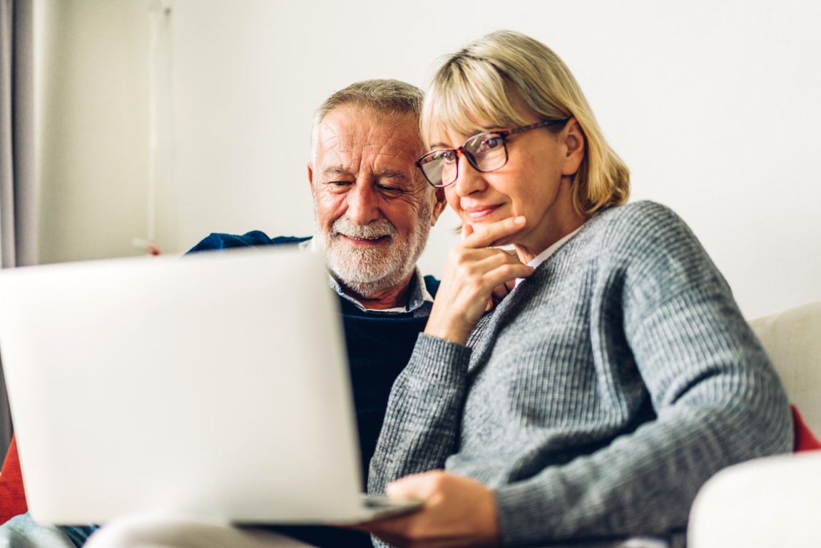 Older adults discussing a Lasting Power of Attorney reviewing legal documents at a table