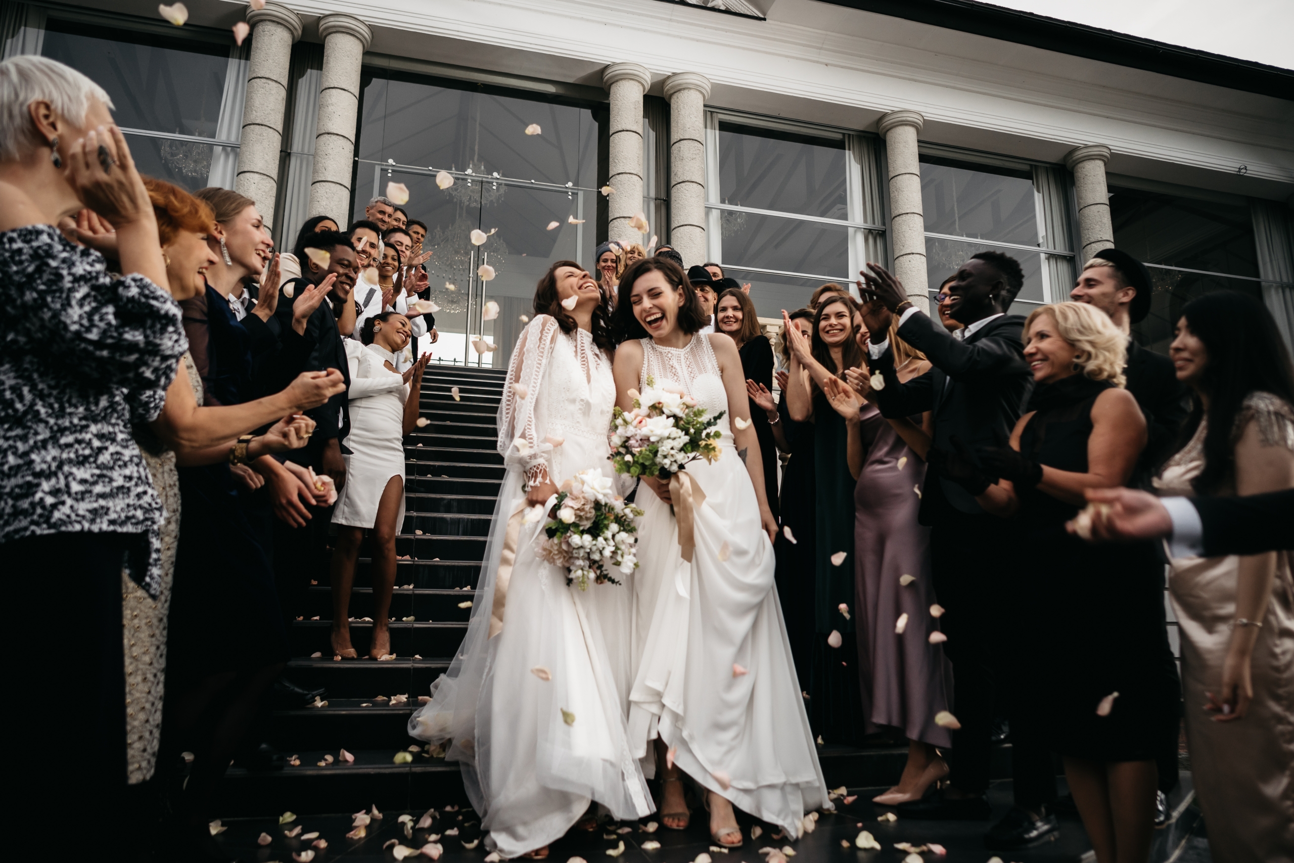 Female lesbian LGBT brides walking down the stairs during their wedding ceremony