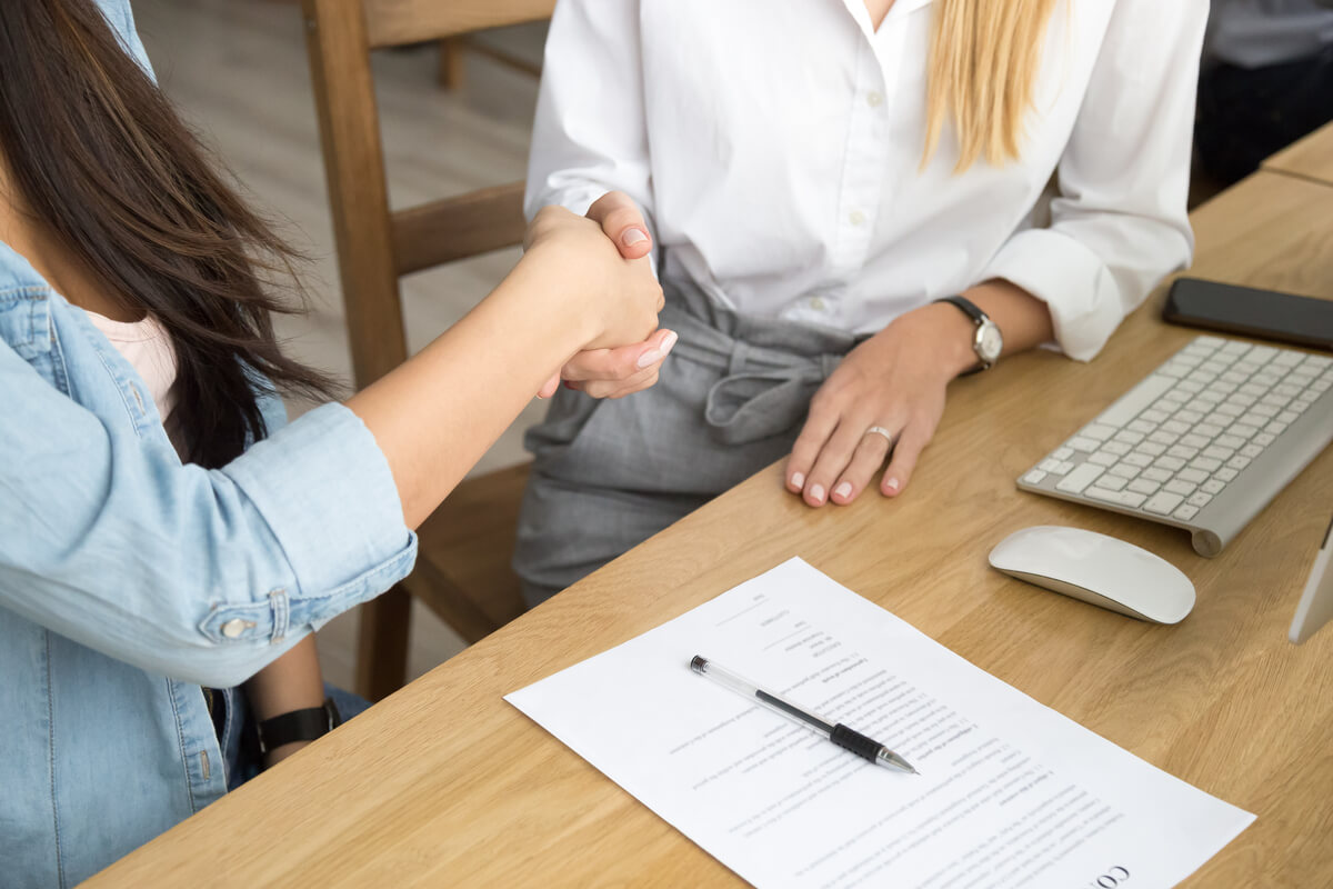 two-women-partners-handshaking-after-signing-business-contract-meeting (1) (1)