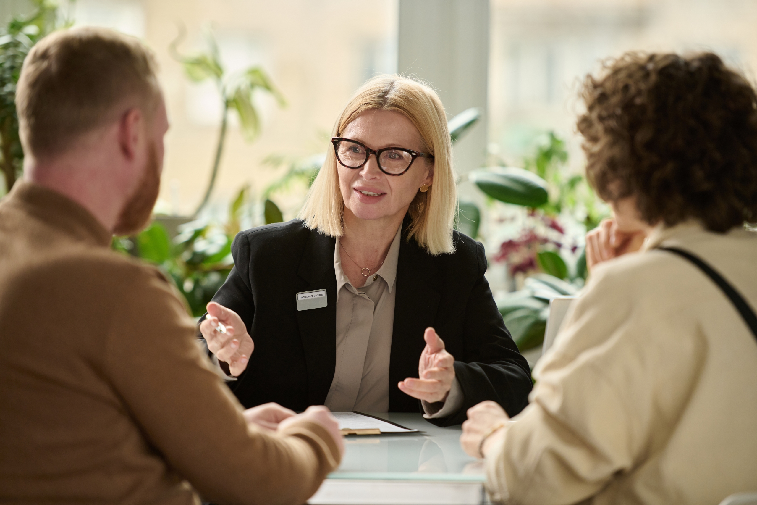 Portrait of female insurance broker consulting couple image of female lawyer discussing finances